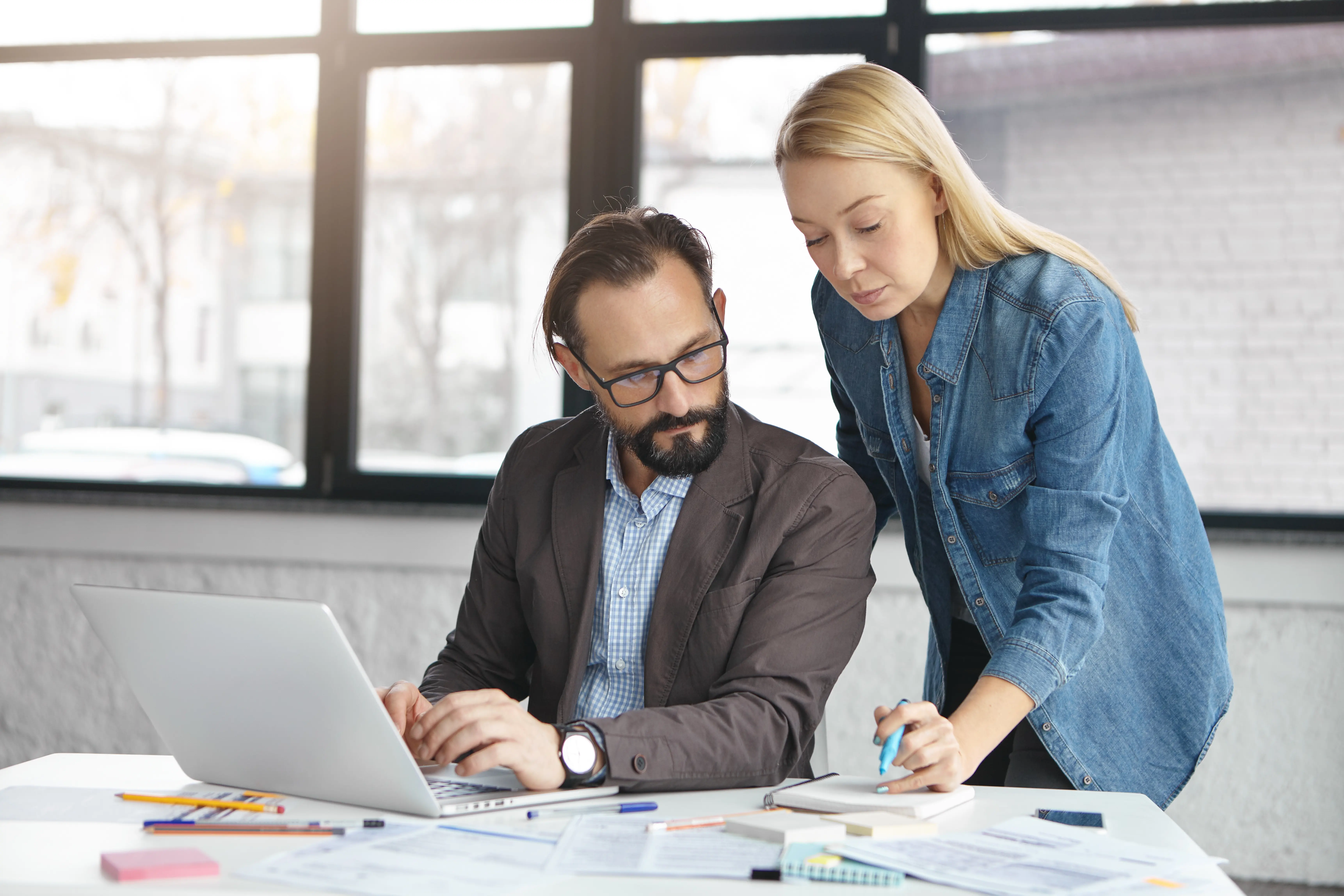 happy-blonde-female-manager-has-conversation-with-male-colleague