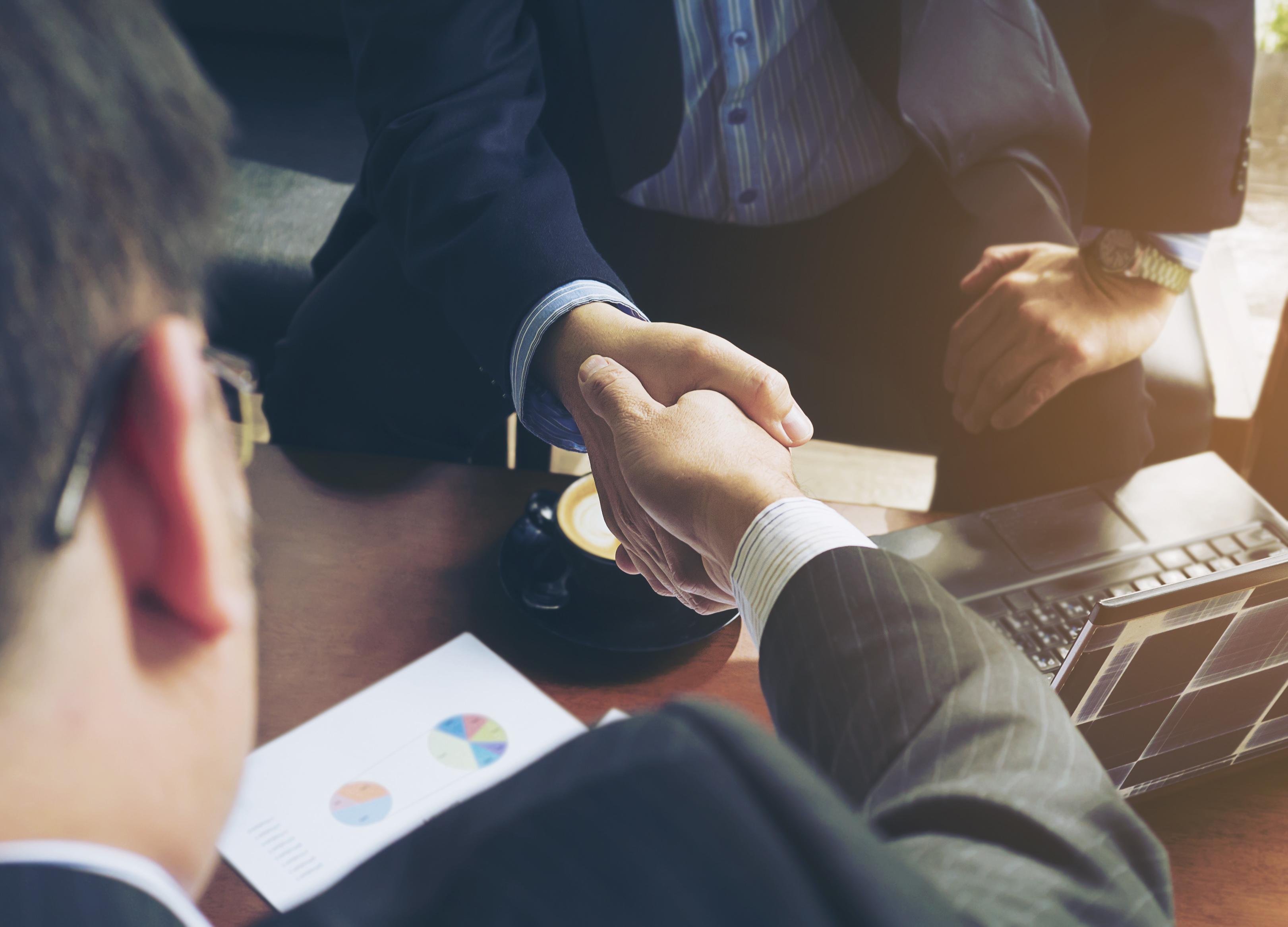 two-businessman-shake-hand-coffee-shop